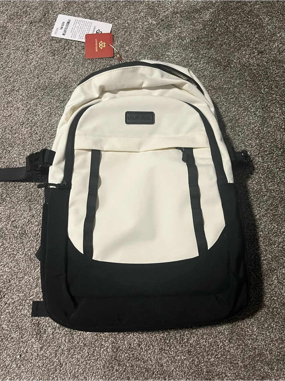 Two-Tone Black and Cream Backpack with Pom Pom Charm